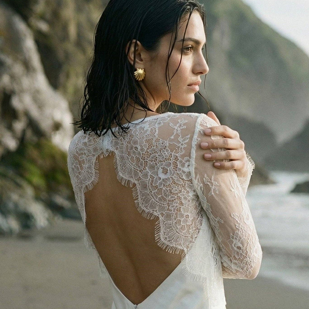 Top de mariée en dentelle blanche à manches longues porté sur une robe nuisette